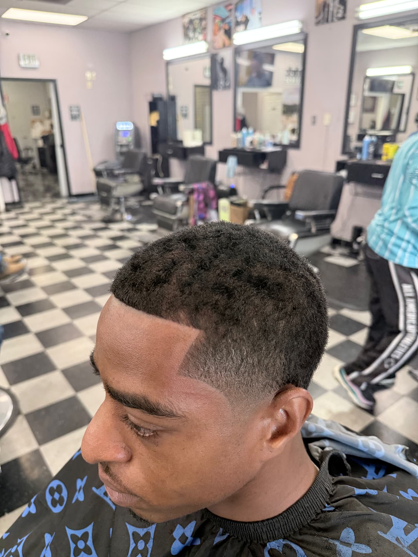 Textured haircut with a clean temple fade